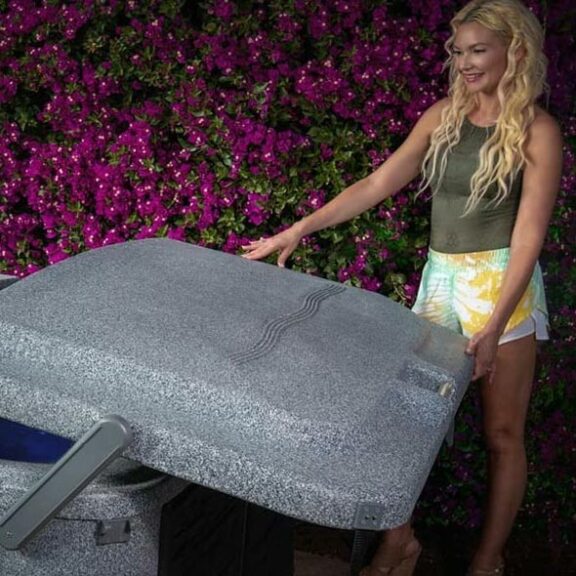 EcoSpa Elite woman opening spa hardcover top